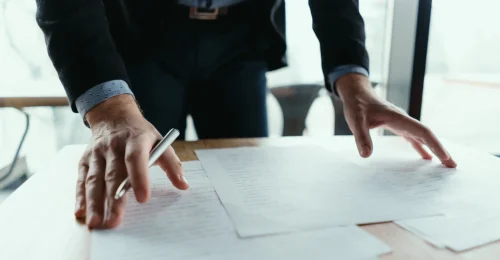 successful-business-man-signing-documents-modern-office (1)